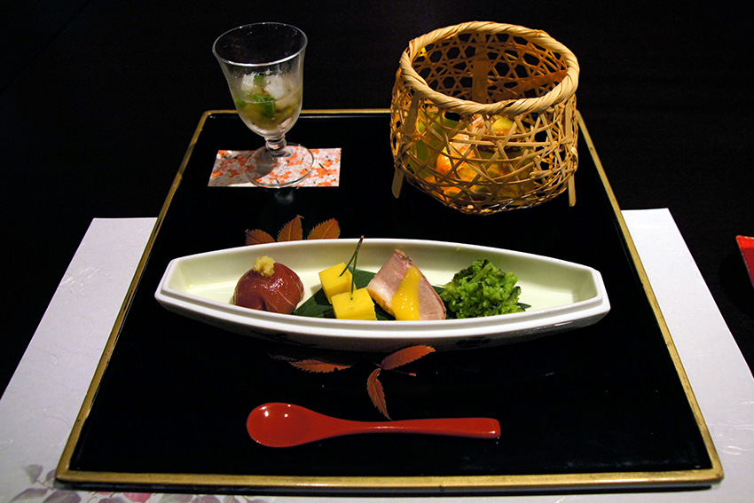 Moritsuke in Japan – Vorspeise kunstvoll und ausgewogen angerichtet Japanische Vorspeise im Moritsuke-Stil auf rechteckigem Tablett mit Keramikschale, saisonalem Gemüse, Fisch, Bambuslicht und Glas als Beispiel für ästhetisches Anrichten